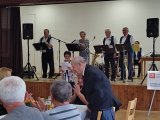 Setkání důchodců - starostka obce Dražíč pronášející řeč do mikrofonu k účastníkům setkání 